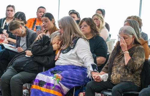 Laura Arndt, centre, an intergenerational survivor, gives support to Mohawk Institute residential school survivors Sherlene Bomberry, left, and Diane Hill, right, as they listen to the preliminary declaration at the Permanent Peoples' Tribunal on Missing Children and Unmarked Graves in Canada in Montreal on Friday, May 29, 2026. THE CANADIAN PRESS/Christinne Muschi