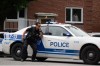 A person looks out of a window as police respond to a shooting in the Côte-des-Neiges district of Montreal on Monday, June 22, 2026. THE CANADIAN PRESS/Christopher Katsarov