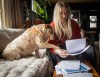 Data centre opponent Bek MacIntosh reviews documents about the proposed centre with the help or her dog Callie at her home in Olds, Alta., Friday, April 24, 2026.THE CANADIAN PRESS/Jeff McIntosh