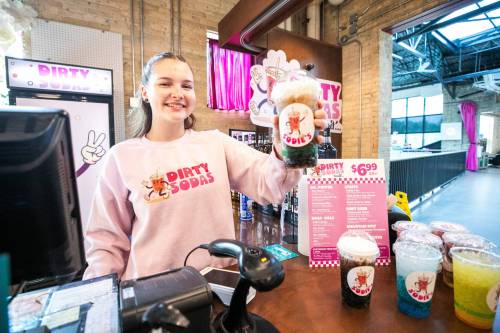 MIKAELA MACKENZIE / FREE PRESS 
                                Kalila Sullivan serves up the Coke Colada at Sodie&rsquo;s Dirty Sodas, located at the Forks Trading Company.
