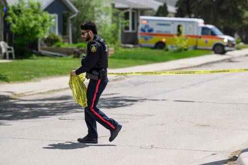 Mike Sudoma/Free Press A WPS officer puts up police tape across King Edward St near St Mathews Ave Friday afternoon May 29, 2026