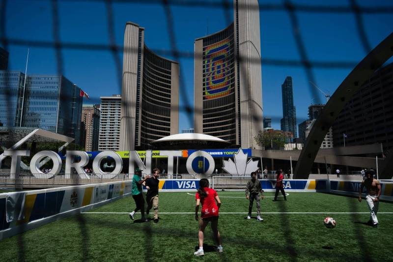 Laura Proctor / Free Press 
                                Residents enjoy one of the two temporary soccer pitches set up in downtown Toronto as part of the city&rsquo;s month-long World Cup celebration.
