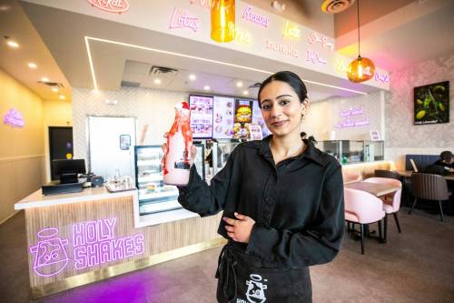MIKAELA MACKENZIE / FREE PRESS
                                Ivleen Pandher with a Madonna Strawberry milkshake at Holy Shakes at St. Vital Centre.