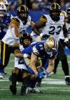 JOHN WOODS / THE CANADIAN PRESS
                                Winnipeg Blue Bombers receiver Tommy Nield fights for yards against the Hamilton Tiger-Cats defence. The receiver had his first career 100-yard game on Thursday night.