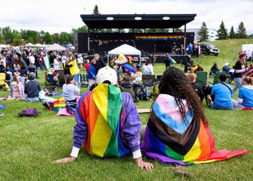 MIKE SUDOMA/FREE PRESS
                                David and Kristen travelled sit on the grass and take in the festivities Saturday at the Triple E main stage in Winkler during Winkler's first Pride celebration Saturday afternoon.