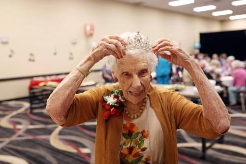 16062026 One-hundred-and-five year old Edith Edmundson laughs while trying on a tiara gifted to her by longtime friend Georgette Ashcroft during her birthday celebration at the Victoria Inn in Brandon, Manitoba on Tuesday. Edmundson turned 105 on June fourth and is celebrating her birthday four times. Festivities started last week in B.C. where Edmundson has been living with her daughter Rhonda Kremko for the last four years. Last Saturday friends and relatives raised a glass to her in Shoal Lake. Her fourth party will be this weekend in Winnipeg. (Tim Smith/The Brandon Sun)
                                Tim Smith/The Brandon Sun
                                Edith Edmundson tries on a tiara gifted to her by longtime friend Georgette Ashcroft during her 105th birthday party in Brandon.