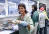 RUTH BONNEVILLE / FREE PRESS
                                LOCAL - volunteer Photo of volunteer, Kishwar Mirza, helping to serve breakfast at Siloam Mission Thursday. Story: Kishwar Mirza is a volunteer at Siloam Mission where she works with 12 to 16 volunteers daily to prepare breakfast. June 18, 2026