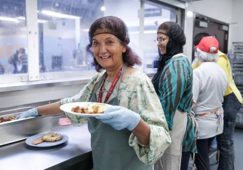 RUTH BONNEVILLE / FREE PRESS
                                LOCAL - volunteer Photo of volunteer, Kishwar Mirza, helping to serve breakfast at Siloam Mission Thursday. Story: Kishwar Mirza is a volunteer at Siloam Mission where she works with 12 to 16 volunteers daily to prepare breakfast. June 18, 2026