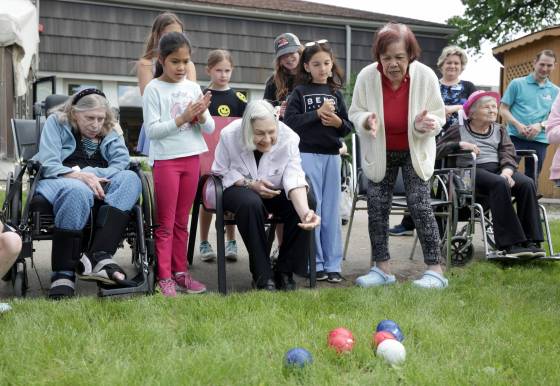 Grade 4 students from Ecole Tuxedo Park cheer on residents at Extendicare Tuxedo Villa while playing bocce during their final visit to the care home for the year, Thursday. (Ruth Bonneville / Free Press)