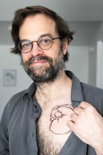 MIKAELA MACKENZIE / FREE PRESS
                                Masse shows the tattoo of his beloved dog, created by using ashes in the ink.