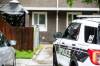 MIKAELA MACKENZIE / FREE PRESS
                                Police officers, including a forensic unit, left the townhouse at about 2 p.m. Friday.