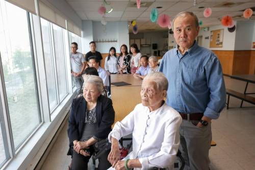 RUTH BONNEVILLE / FREE PRESS 
                                Vietnamese Association of Manitoba spokesperson Quanhai Tonthat, (right) with Vietnamese community members and residents of Saigon Centre in the multi-purpose room they use regularly.