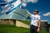 BROOK JONES/FREE PRESS
                                Jonathan K. waves an Israeli flag in front of the Canadian Museum for Human Rights during the protest, Friday.