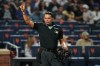 Home plate umpire Emil Jimenez gestures to players during the eighth inning of a baseball game between the New York Mets and the Cincinnati Reds Tuesday, May 26, 2026, in New York. (AP Photo/Frank Franklin II)