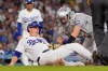 Los Angeles Dodgers' Will Smith, left, is tagged out by Colorado Rockies catcher Hunter Goodman as he tries to score on a single by Alex Call during the fourth inning of a baseball game Wednesday, May 27, 2026, in Los Angeles. (AP Photo/Mark J. Terrill)