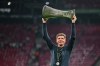 Crystal Palace's head coach Oliver Glasner celebrates with the trophy after winning the Europa Conference League final soccer match between Crystal Palace and Rayo Vallecano in Leipzig, Germany, Wednesday, May 27, 2026. (Robert Michael/dpa via AP)