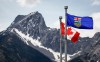 A Canada flag, left, and an Alberta flag flap in the breeze with Wedge Mountain in the background in Kananaskis, Alta., on Monday, June 2, 2025. Conservative Leader Pierre Poilievre is expected to call for a shift in federal policies as an antidote for separatist sentiment in Alberta when he speaks in Calgary on Monday. THE CANADIAN PRESS/Jeff McIntosh