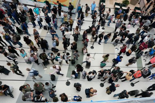 FILE - Travelers wait in long security checkpoint lines at George Bush Intercontinental Airport March 27, 2026, in Houston. (AP Photo/David J. Phillip, File)
