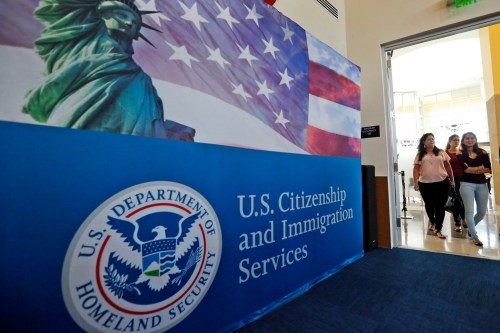 FILE - In this Aug. 17, 2018, file photo, people arrive before the start of a naturalization ceremony at the U.S. Citizenship and Immigration Services Miami Field Office in Miami. (AP Photo/Wilfredo Lee, File)