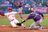 Los Angeles Angels' Logan O'Hoppe, left, scores after a single by Vaughn Grissom and a throwing error by Sterlin Thompson as Colorado Rockies catcher Hunter Goodman misses the ball during the second inning of a baseball game Wednesday, June 3, 2026, in Anaheim, Calif. (AP Photo/Mark J. Terrill)