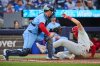 Philadelphia Phillies' Alec Bohm (28) is tagged out at home by Toronto Blue Jays' Tyler Heineman (55) during third inning MLB baseball action in Toronto, on Monday, June 8, 2026. THE CANADIAN PRESS/Sammy Kogan