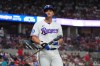 Texas Rangers' Corey Seager heads to the dugout after hitting into an unassisted double play flyout with teammate Kyle Higashioka out at first base during the sixth inning of a baseball game against the Cleveland Guardians, Saturday, June 6, 2026, in Arlington, Texas. (AP Photo/LM Otero)