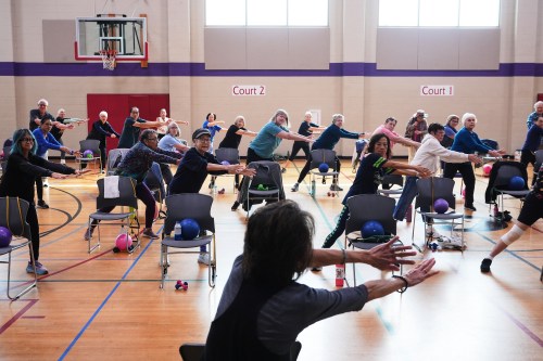 Instructor Bengie Santos, 72, at front, leads an exercise class for older adults at the Dale Turner Family YMCA, April 30, 2026, in Shoreline, Wash. (AP Photo/Lindsey Wasson)