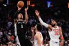 San Antonio Spurs forward Victor Wembanyama (1) shoots over New York Knicks center Karl-Anthony Towns (32) during second half of Game 3 of the NBA Finals basketball series, Monday, June 8, 2026, in New York. (AP Photo/Ross D. Franklin)