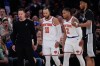 New York Knicks guard Jalen Brunson (11) and guard Miles McBride (2) walk to their bench as San Antonio Spurs head coach Mitch Johnson, left, looks away during second half of Game 3 of the NBA Finals basketball series, Monday, June 8, 2026, in New York. (AP Photo/Ross D. Franklin)