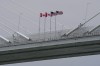 Canadian and American flags fly in the breeze on the Gordie Howe Bridge under construction between Windsor, Ont., and Detroit on May 22, 2026. (AP Photo/Paul Sancya, File)