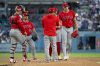 Los Angeles Angels starting pitcher Jack Kochanowicz, right, is being removed during the first inning of a baseball game against the Los Angeles Dodgers in Los Angeles, Saturday, June 6, 2026. (AP Photo/Kyusung Gong)