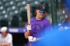 Colorado Rockies outfielder Cole Carrigg warms up before a baseball game against the Chicago Cubs Tuesday, June 9, 2026, in Denver. (AP Photo/David Zalubowski)