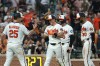 Baltimore Orioles' Jackson Holliday, center, celebrates his grand slam home run with Pete Alonso (25) hit off Seattle Mariners pitcher Domingo Gonzalez which scored Taylor Ward, Pete Alonso and Leody Taveras during the seventh inning of a baseball game, Wednesday, June 10, 2026, in Baltimore. (AP Photo/Terrance Williams)