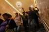 People walk through a subway station that has new lighting, part of preparations for hosting the World Cup soccer tournament in Mexico City, Wednesday, June 10, 2026. (AP Photo/Marco Ugarte)