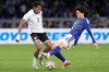 FILE -Bolivia's Diego Medina, left, and Japan's Keisuke Goto, right, fight for the ball during an international friendly soccer match between Japan and Bolivia in Tokyo, Nov. 18, 2025. (AP Photo/Eugene Hoshiko, File)