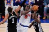 New York Knicks forward OG Anunoby (8) shoots between San Antonio Spurs forward Victor Wembanyama (1) and guard De'aaron Fox (4) during the first half of Game 4 of the NBA Finals basketball series, Wednesday, June 10, 2026, in New York. (AP Photo/Ross D. Franklin)