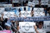 Vancouver Whitecaps fans hold signs before the first half of an MLS soccer match against the Colorado Rapids in Vancouver, on Saturday, April 25, 2026. THE CANADIAN PRESS/Ethan Cairns