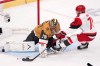 Vegas Golden Knights goaltender Carter Hart, left, stops a shot by Carolina Hurricanes left wing Taylor Hall during the first period in Game 4 of the NHL hockey Stanley Cup Final series Tuesday, June 9, 2026, in Las Vegas. (AP Photo/Candice Ward)