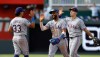 Texas Rangers' Nicky Lopez (33) Ezequiel Duran, center, and Wyatt Langford, right, celebrate at the end of a baseball game against the Kansas City Royals in Kansas City, Mo., Thursday, June 11, 2026. (AP Photo/Colin E. Braley)