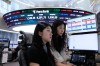 Currency traders watch monitors at the foreign exchange dealing room of the Hana Bank headquarters in Seoul, South Korea, Friday, June 12, 2026. (AP Photo/Ahn Young-joon)