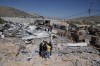 Palestinians walk through the rubble of their properties after Israeli authorities demolished a large section of the main vegetable market of the West Bank village of Beita, southeast of Nablus, Monday, June 1, 2026. (AP Photo/Majdi Mohammed)