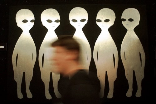 FILE - A patron passes a painting inside the International UFO Museum and Research Center in Roswell, N.M., on June 10, 1997. (AP Photo/Eric Draper, File)