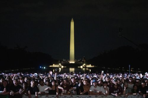 Audience members cheer and boo during a UFC news conference at the Lincoln Memorial, ahead of Sunday's fight on the South Lawn of the White House, Friday, June 12, 2026, in Washington. (AP Photo/Allison Robbert)