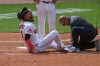 Cleveland Guardians' Angel Martinez grimaces as he is worked on by a trainer after being hit by a foul tip against the Detroit Tigersinning of a baseball game, Saturday, June 13, 2026, in Cleveland. (AP Photo/Phil Long)