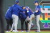 Chicago Cubs right fielder Seiya Suzuki, center front, is checked after being injured while attempting to catch a fly ball during the fourth inning of a baseball game against the San Francisco Giants, Saturday, June 13, 2026, in San Francisco, Calif. (AP Photo/Scott Marshall)