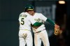 Athletics shortstop Jacob Wilson (5) and Colorado Rockies second baseman Alika Williams (12) embrace following the Athletics victory of the Colorado Rockies during a baseball game Saturday, June 13, 2026, in Las Vegas. (AP Photo/Caroline Brehman)