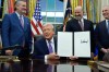 FILE - Flanked by Sen. Ted Cruz, R-Texas, left, Secretary of Commerce Howard Lutnick, second right, and White House AI and Crypto Czar David Sacks, President Donald Trump displays his signed AI initiative in the Oval Office of the White House, Dec. 11, 2025, in Washington. (AP Photo/Alex Brandon, File)