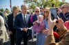 Canadian Prime Minister Mark Carney, front left, has a picture taken with Lily Meskil, 9 months and her grandfather Ger Basquel and mother Rachel Basquel, during a visit to Aughagower, Ireland, Sunday, June 14, 2026. (Andrew Downes/PA via AP)