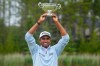 Sudarshan Yellamaraju, of Mississauga, Ont., holds his trophy for lowest Canadian score at the RBC Canadian Open, in Caledon, Ont. on Sunday June 14, 2026. THE CANADIAN PRESS/Frank Gunn