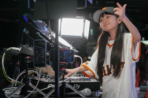 Nine-year-old DJ Rinoka performs at Tokyo Dome before a Yomiuri Giants baseball game on May 24, 2026, in Tokyo. (AP Photo/Eugene Hoshiko)